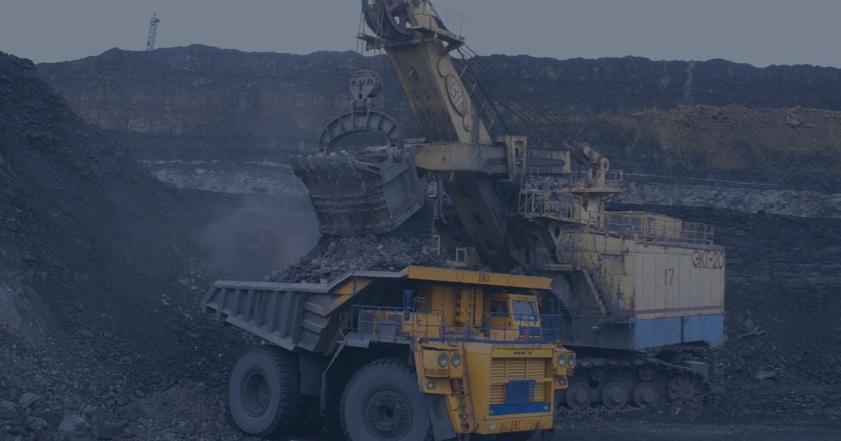 Large electric rope shovel loading mined material into a haul truck at an open-pit mining site
