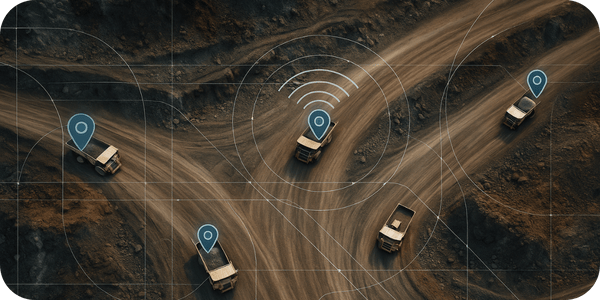 Aerial view of multiple haul trucks on intersecting mine roads, each marked with GPS tracking indicators.