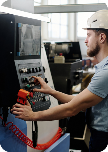 CNC operator reviewing precision cutting on monitor