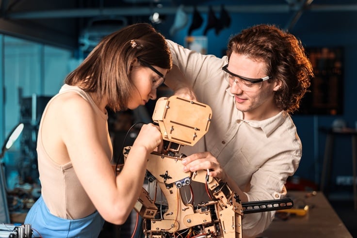 Technicians in protective glasses inspecting a rebuilt component